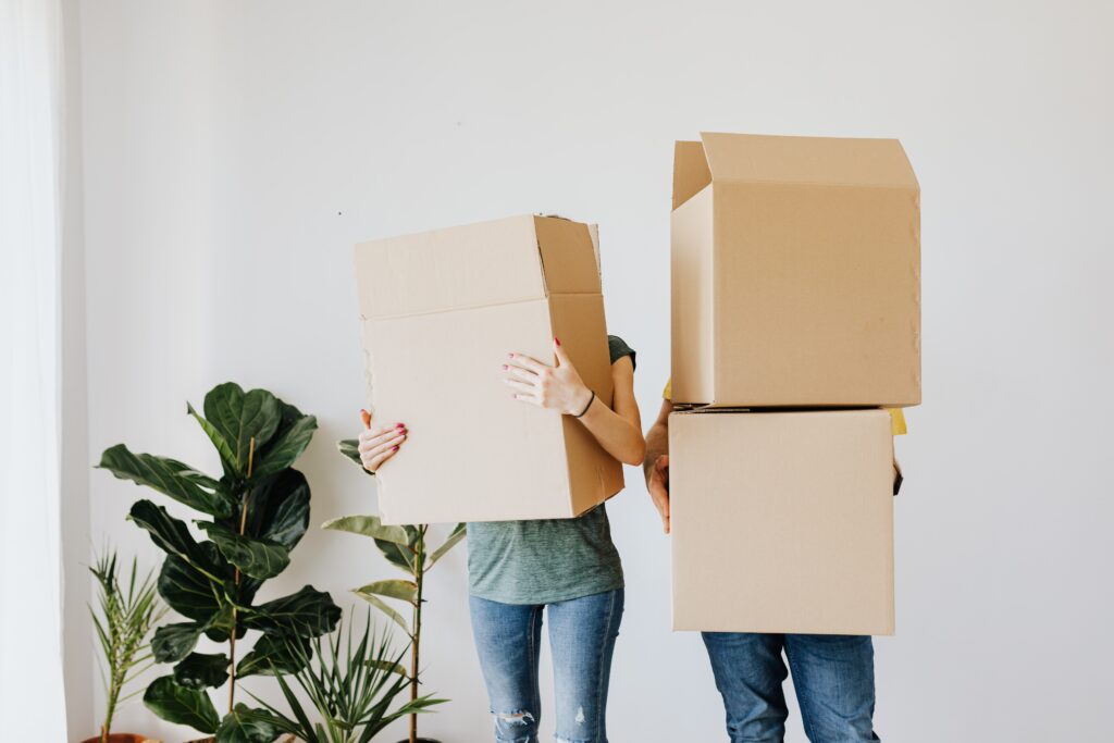 Two people moving with large boxes