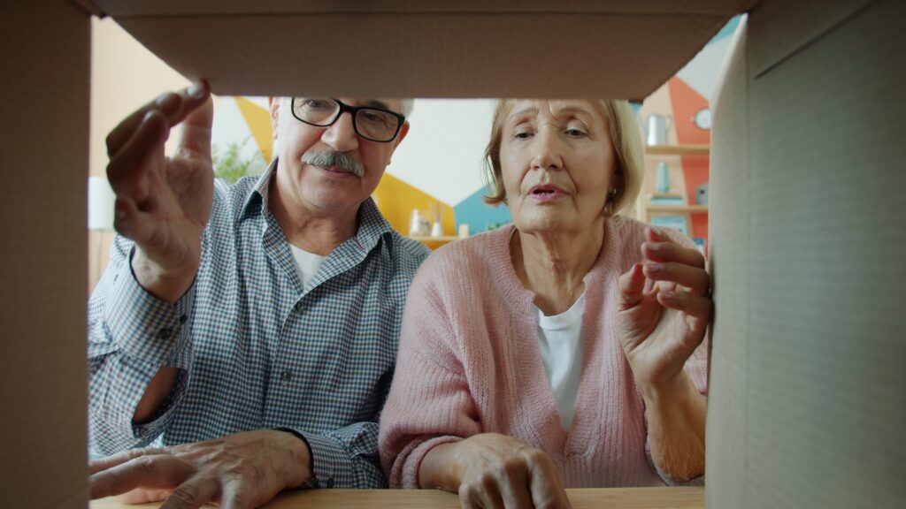 Elder couple opening a box