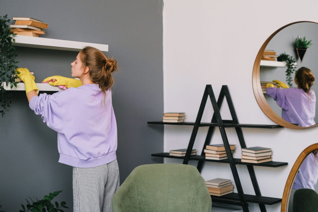 Woman cleaning shelf