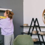 Woman cleaning shelf